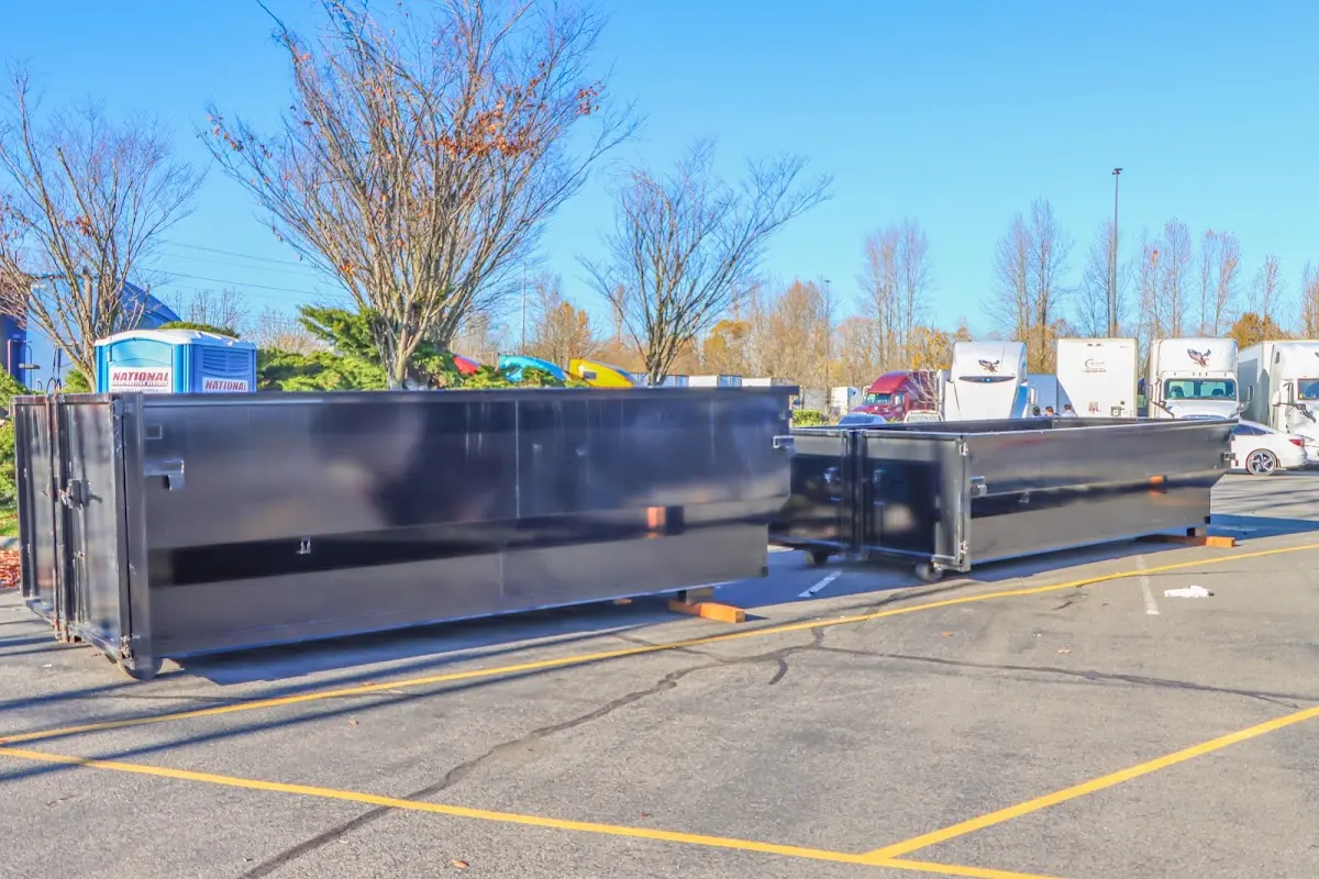 Professional dumpster rental service with roll-off container on residential driveway in Cave Spring